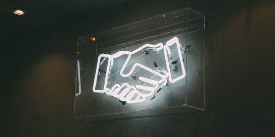 Neonschild zwei Hände beim Händeschütteln